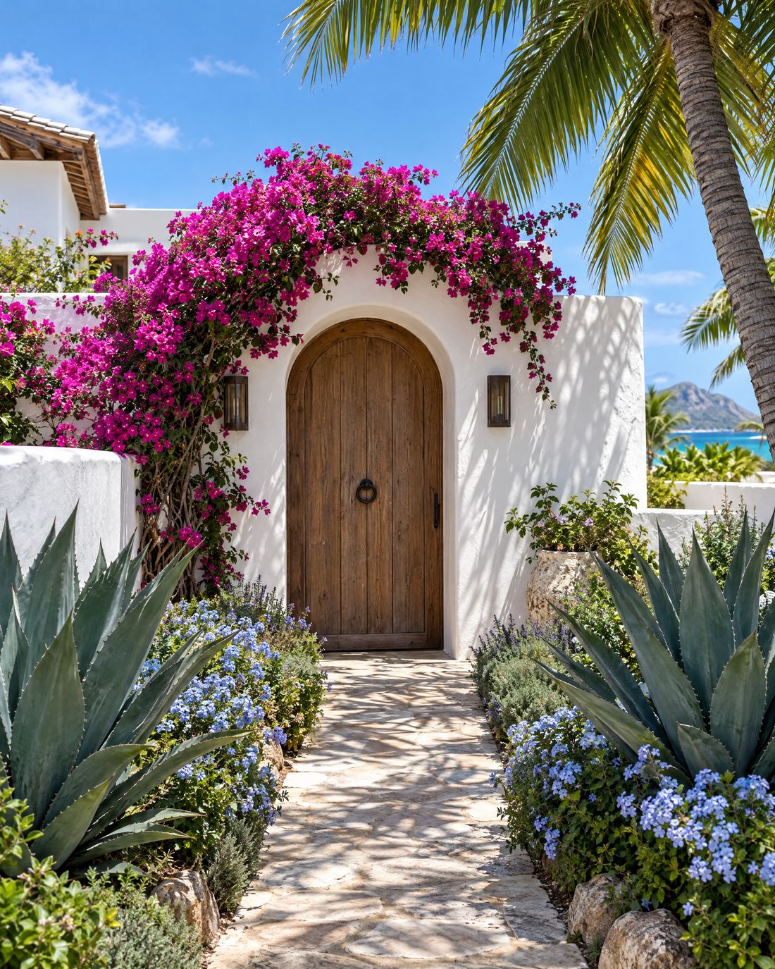 Arched timber villa door under bougainvillea